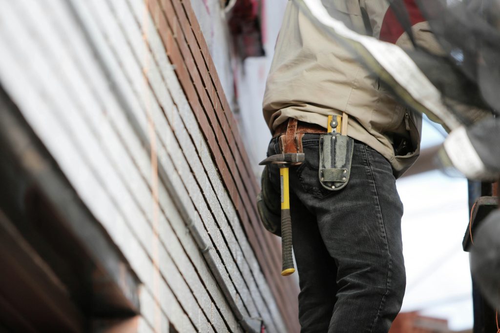 a contractor carrying a hammer